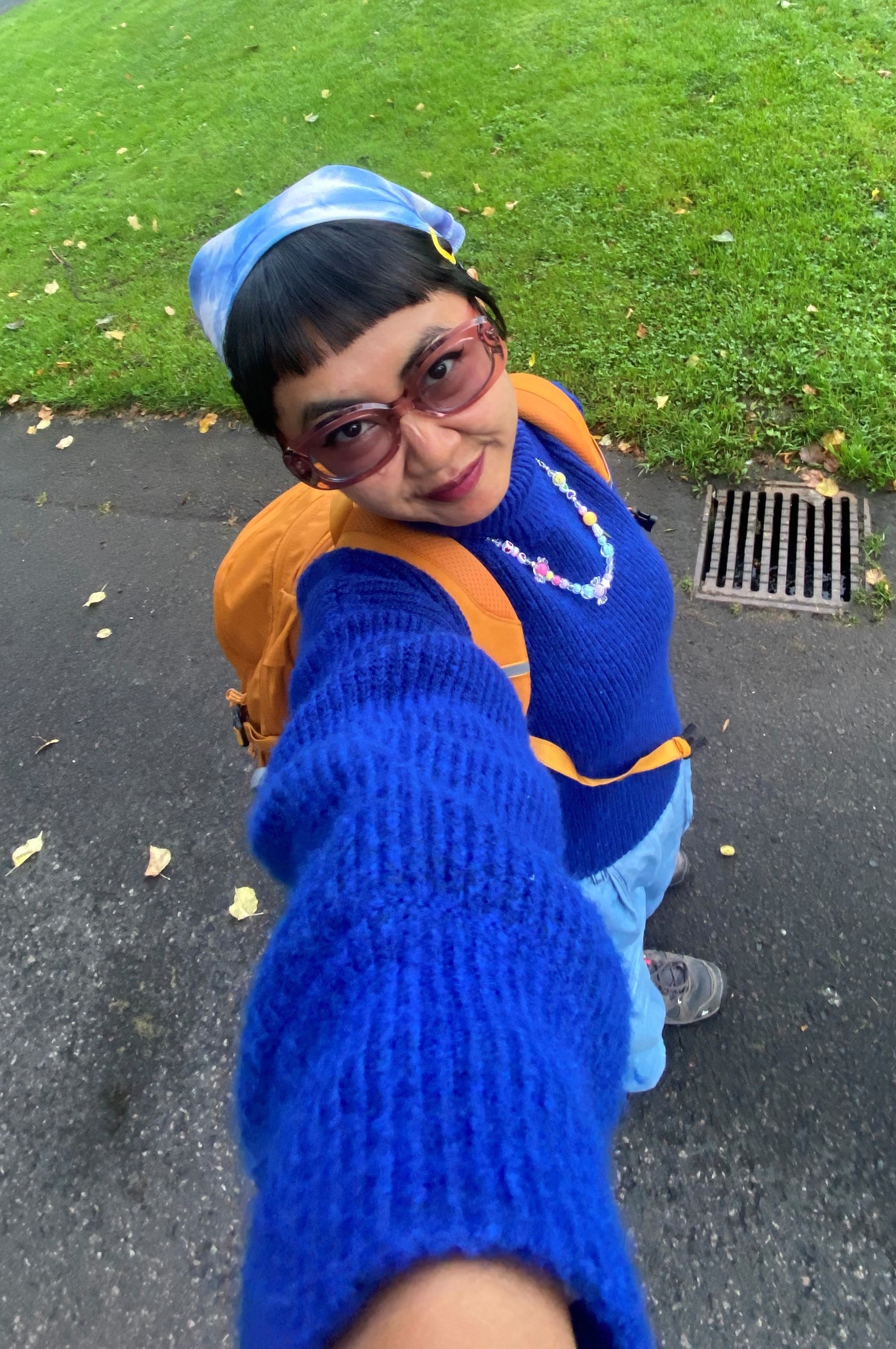 Woman in sunglasses with blue sweater