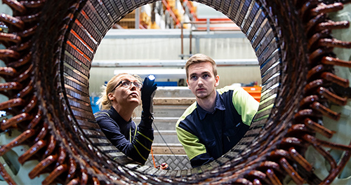 Two people in an industrial environment